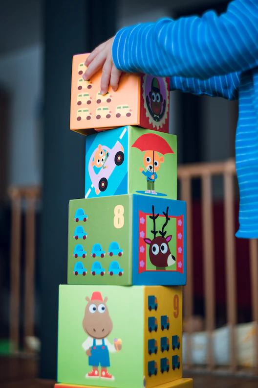 Child stacks blocks